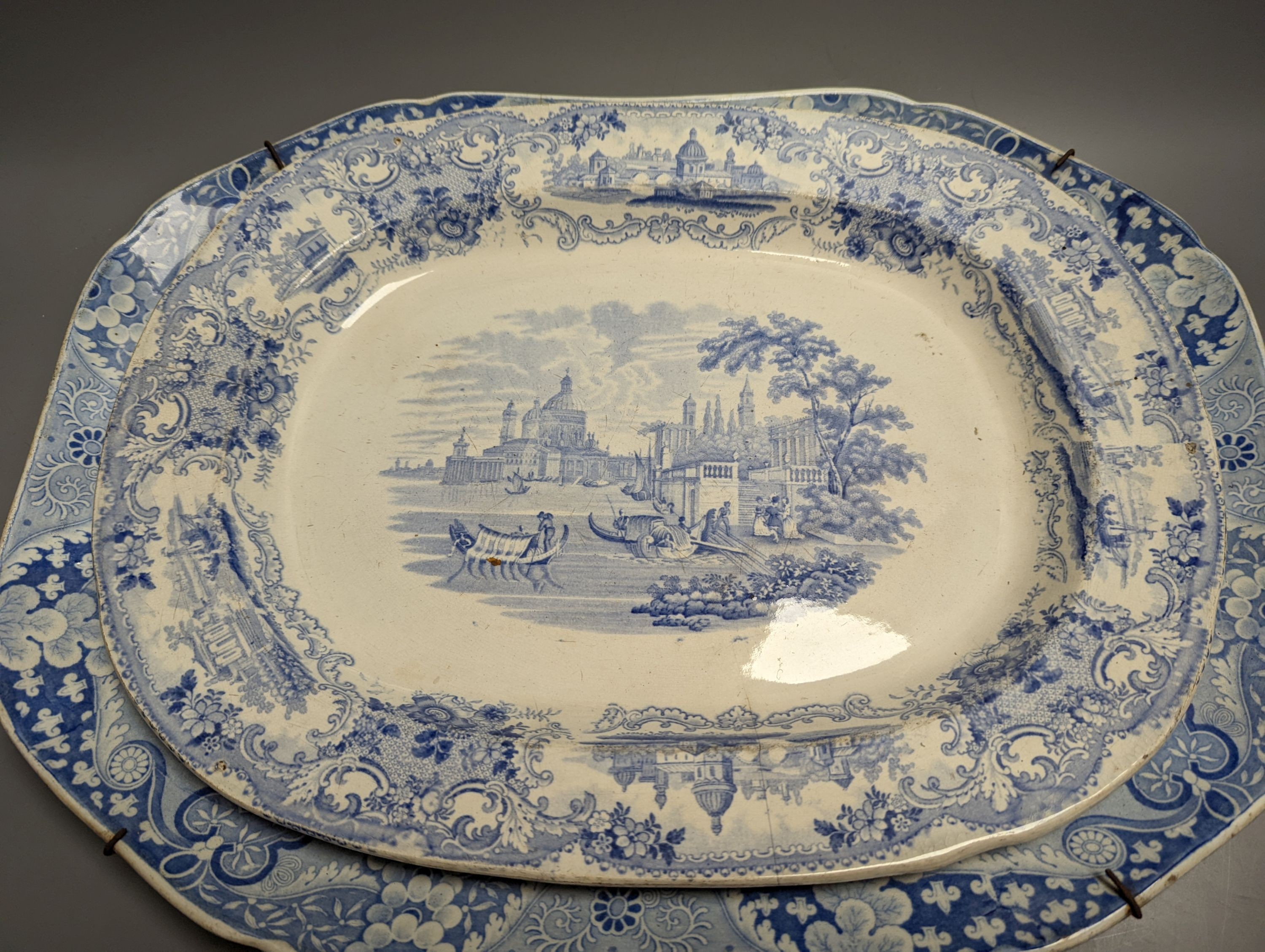 Two 19th century blue and white meat dishes and three similar plates, largest platter 49cms wide